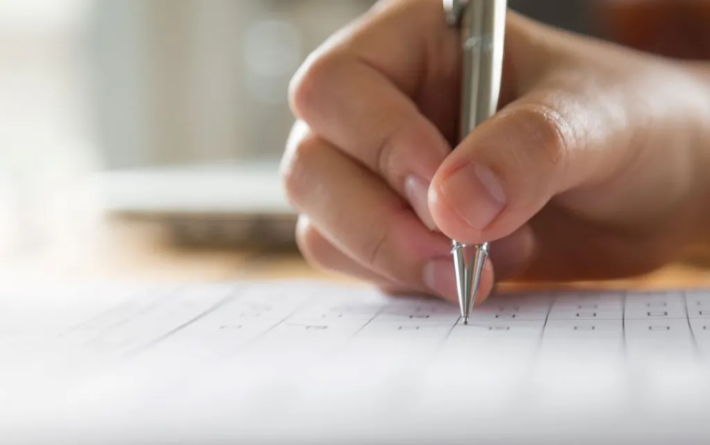 hand-writing-paper-with-pen